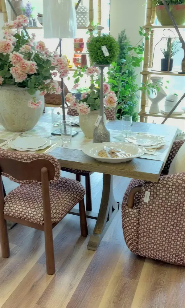 A dining table set with glass and florals